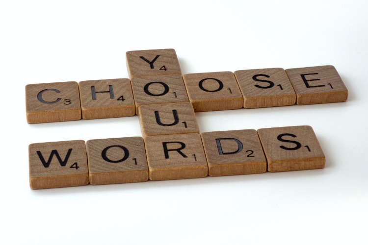 Wooden scrabble tiles arranged into the words choose your words
