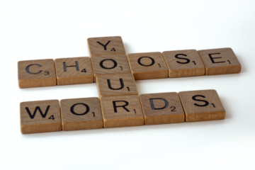 Wooden scrabble tiles arranged into the words choose your words